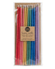 Package of 12 tall hand-dipped beeswax birthday candles in assorted rainbow colors.