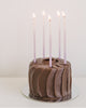 Package of 12 tall hand-dipped violet color beeswax birthday candles with ombré effect