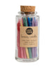 Hand-dipped beeswax candles in assorted rainbow colors, packaged in a glass jar with a cork top.