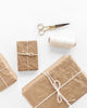 boxes of different sizes wrapped in crinkled kraft paper and twine tied in a bow