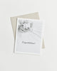 Greeting card with a black and white photo of baby feet and “Congratulations!” in cursive.