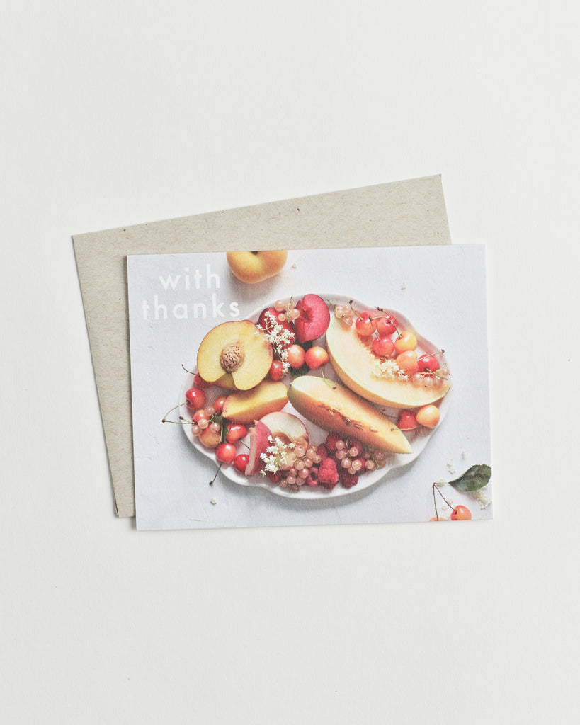 Photo greeting card of a fruit bowl from above and words “with thanks”.