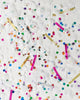 Knot and Bow classic party confetti mix of white and metallic rainbow scattered over a white background.
