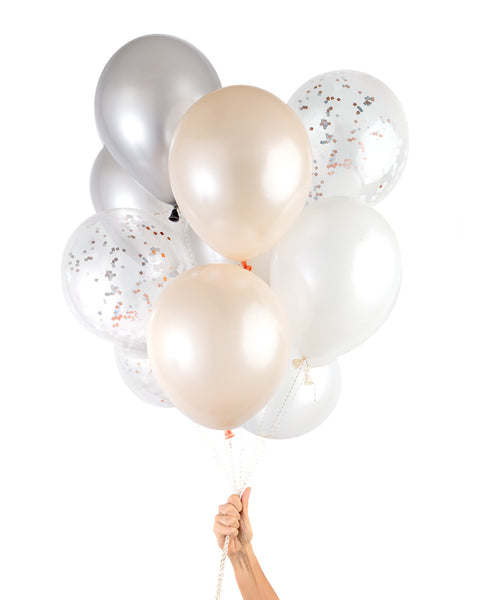 Bunch of party balloons in a mix of blush and metallic colors and clear balloons filled with metallic copper confetti