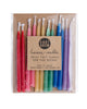 Package of 12 tall hand-dipped beeswax birthday candles in assorted rainbow colors.