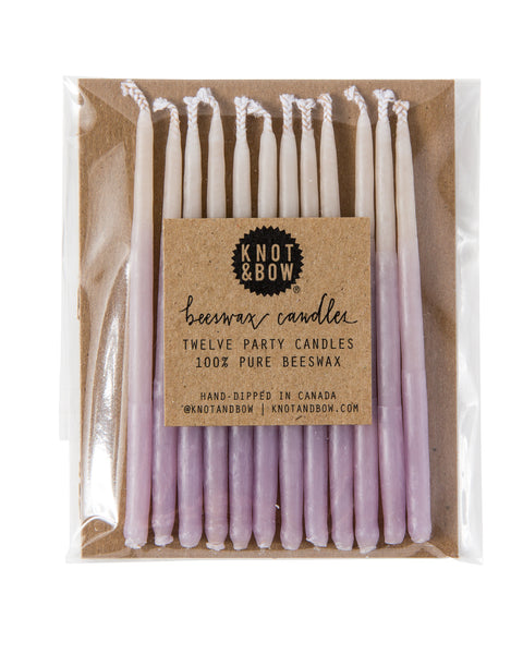 Package of 12 hand-dipped violet color beeswax birthday candles with ombré effect