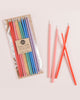 Package of 12 tall hand-dipped beeswax birthday candles in assorted rainbow colors.