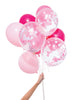 Bunch of party balloons in a mix of pink colors and clear balloons filled with pink confetti